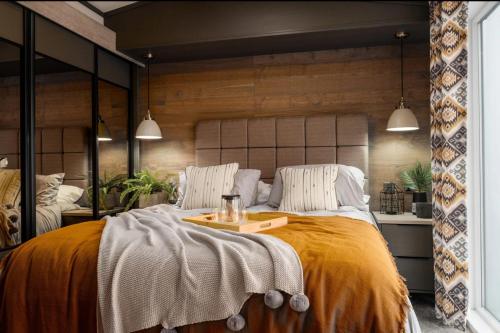 a bedroom with a large bed with a tray on it at Lakewood Lodge in Saint Fillans