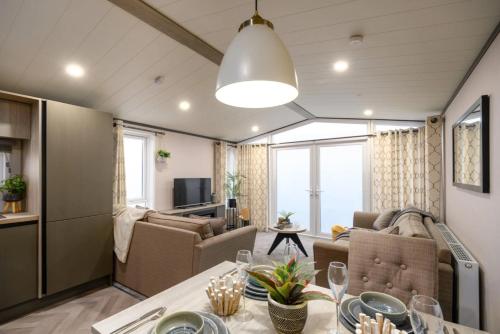 a living room with a couch and a table at Lakewood Lodge in Saint Fillans