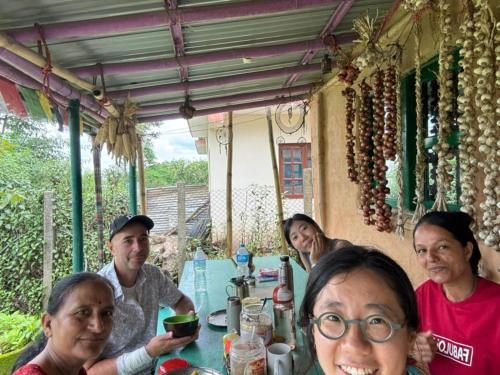 a group of people sitting at a table at Sisters homestay in Nagarkot