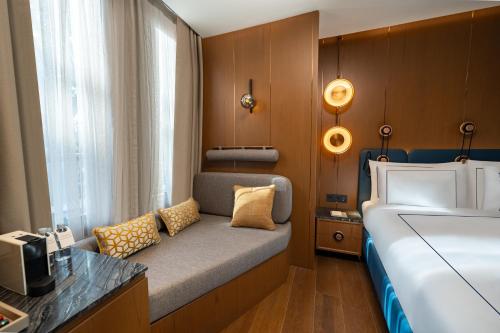 a small bedroom with a bed and a window at Sura Concept Hotel in Istanbul