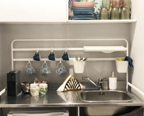 a kitchen counter with a sink and utensils at Sunny Beach Bari in Bari