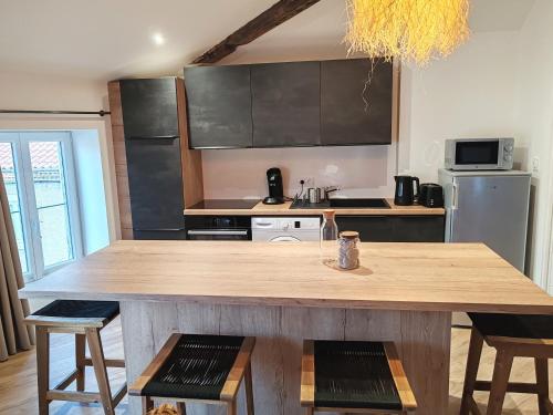 a kitchen with a large wooden table and chairs at La Casa in Montbrison