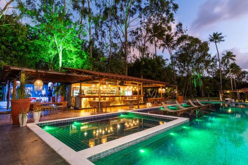 an outdoor pool with a bar and a resort at Eco Luar Boutique Hotel in Igarassu