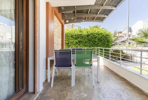 a table and chairs on the balcony of a house at Comfortable villa with garden in “Urla İskele” in Urla