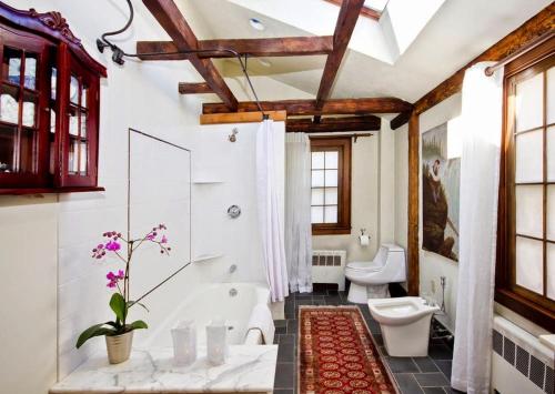 a bathroom with a tub and a toilet and a sink at Moroccan Boutique Guest House in Boston
