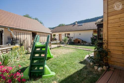 a green ladder in a yard next to a house at Les inseparables in Saint-Pierre-de-Curtille
