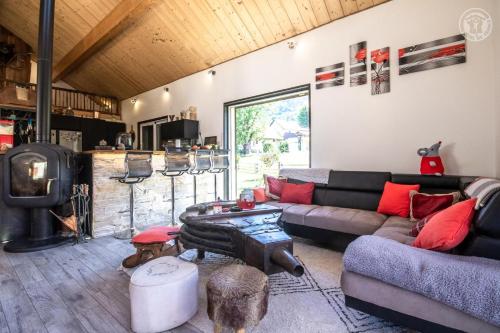 a living room with a couch and a dog at Les inseparables in Saint-Pierre-de-Curtille