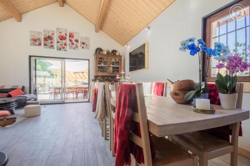 a living room with a wooden table and a dining room at Les inseparables in Saint-Pierre-de-Curtille