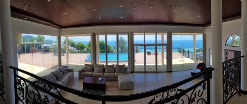 a house with a living room and a pool at Amanda Villa - Best Value Mountain top Inn in Au Cap