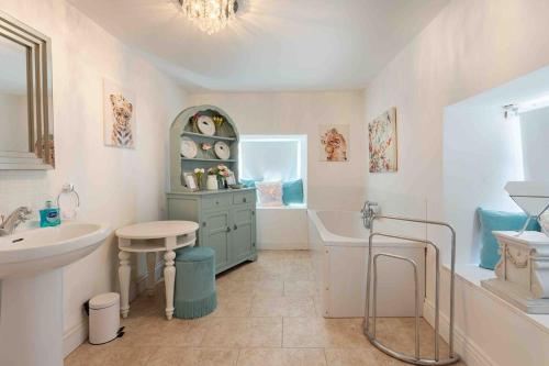 a bathroom with a sink and a bath tub and a sink at Mount Eagle - Sleeps 24 in Limerick
