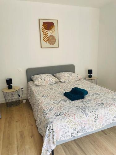 a bedroom with a bed with a blue shirt on it at Le Bastide in Sémalens