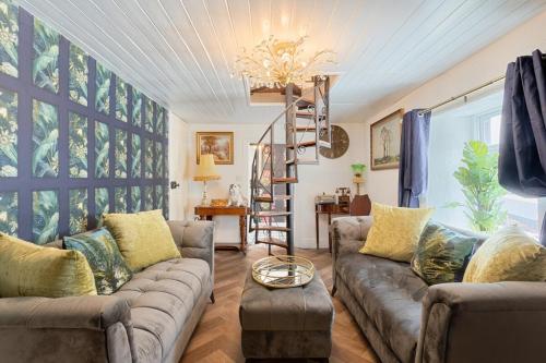 a living room with a couch and a chandelier at Killorglin Irish Pub With Hot Tub That Sleeps 19 in Killorglin