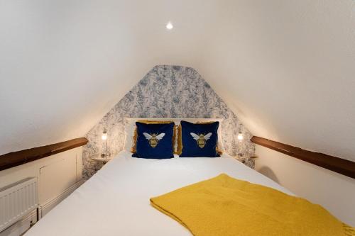 a bedroom with a bed with blue and yellow pillows at Killorglin Irish Pub With Hot Tub That Sleeps 19 in Killorglin