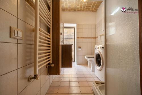 a bathroom with a washer and dryer in a room at Casa Nel Borgo - WelcHome in Lanciano