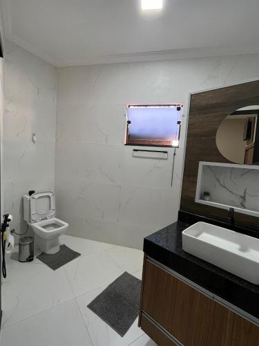 a bathroom with a sink and a toilet at Casa Lua Flat in Brumadinho