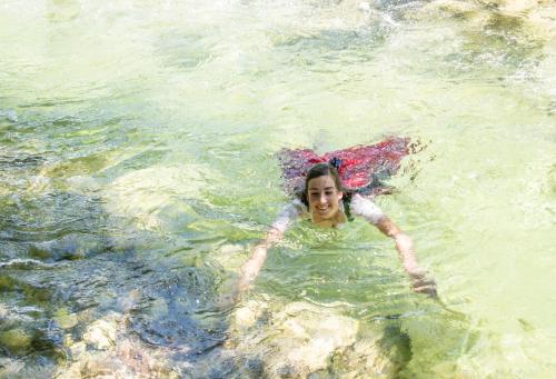a woman swimming in a body of water at Waldruhe - Bett, Frühstück & ein Lächeln in Bad Aussee