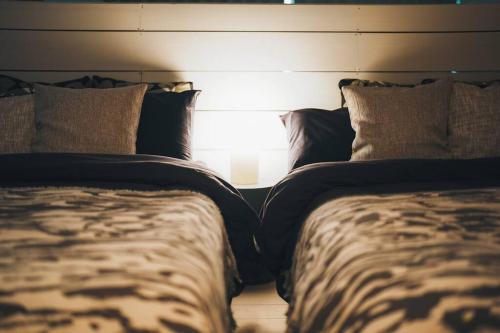 two beds sitting next to each other in a bedroom at 秘密基地白子ベース in Shirako