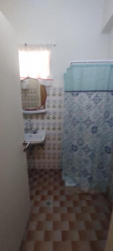 a bathroom with a sink and a shower with a window at Love Greece Dream Pavlaras in Tolo