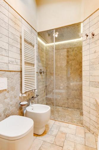 a bathroom with a toilet and a glass shower at Agriturismo Le Bosche in San Marino