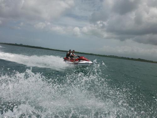 two people on a jet ski in the water at Zenitude Hôtel Résidences Le Salako in Le Gosier