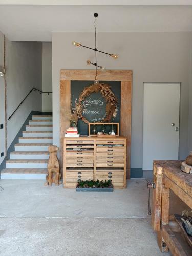 a living room with a dresser and a staircase at B&B Rocambola in Nogara