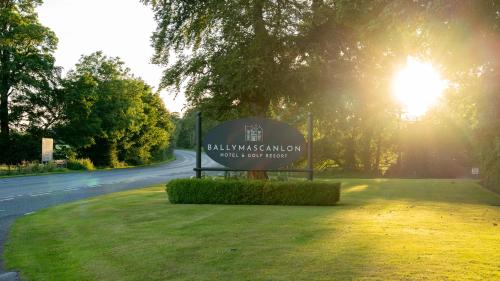 a sign in the grass next to a road at Ballymascanlon Hotel and Golf Resort in Dundalk