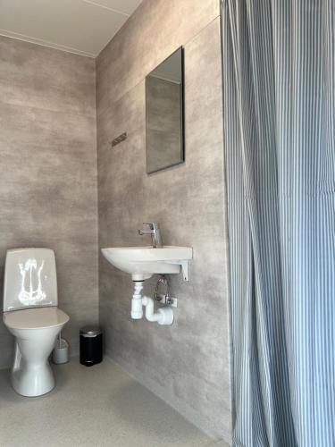 a bathroom with a sink and a toilet at One room apartment the Square in Ystad