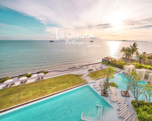 an aerial view of a resort with two pools and the ocean at Veranda Pattaya Sea View Jomtien Beach Front วิวทะเล พัทยา จอมเทียน in Na Jomtien