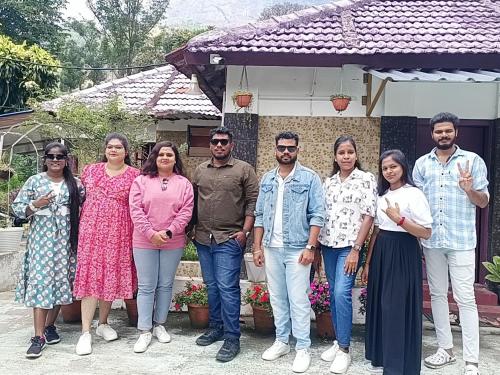 a group of people standing in front of a house at Munnar home stay in Munnar