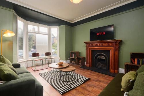 a living room with a couch and a fireplace at Cosy, Stylish, Leafy And Homely in Sheffield