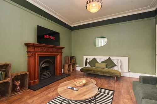 a living room with a couch and a table at Cosy, Stylish, Leafy And Homely in Sheffield