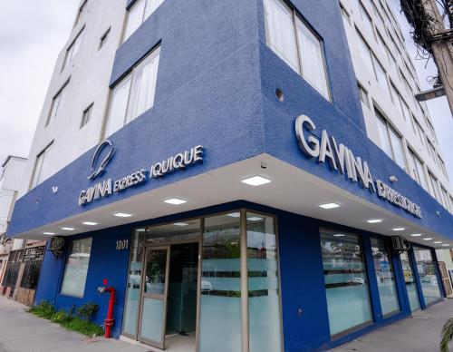 a blue building with a sign on the front of it at HOTEL GAVINA EXPRESS IQUIQUE in Iquique