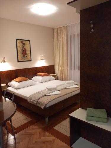 a bedroom with a large bed with white pillows at Apartment Ivan in Vinišće
