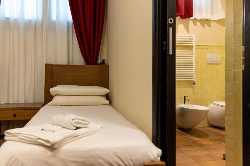 a bedroom with a bed and a tub and a sink at Agriturismo Le Bosche in San Marino