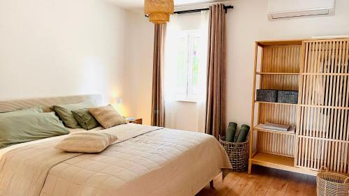a bedroom with a large bed and a window at House Jelka in Supetar