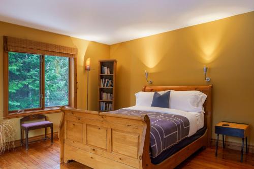 a bedroom with a bed and a book shelf at La Romane Unique Chalet Billard, Spa & Pool in Val-David