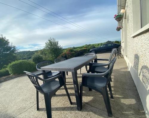 a table and chairs on a patio with a view at Cheerful 3 bedroom house with fantastic views in Shercock