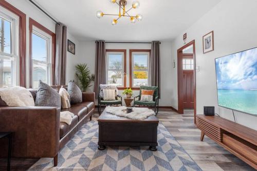 a living room with a couch and a flat screen tv at Renovated 6BR 2BA AC home and Game Room in Atlantic City