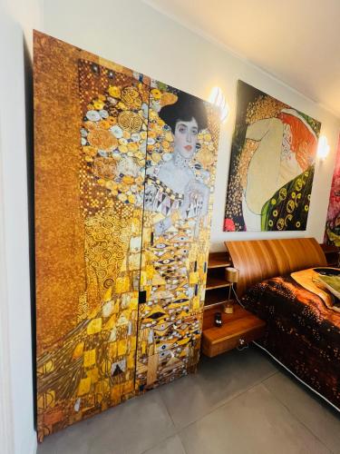 a room with a painting on the wall next to a bed at B&B Rifugio Degli Artisti - Themed Rooms in Monzambano