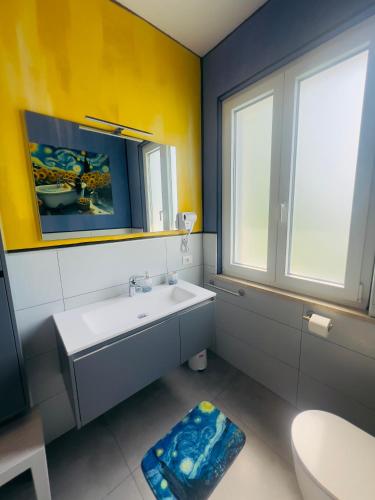 a bathroom with a sink and a toilet and a window at B&B Rifugio Degli Artisti - Themed Rooms in Monzambano
