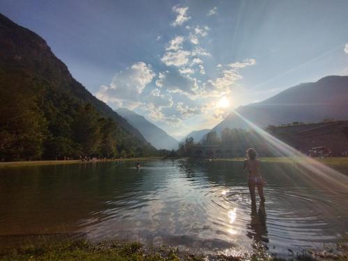 a woman standing in the water in a lake at Vinadio Sole & Relax in Vinadio