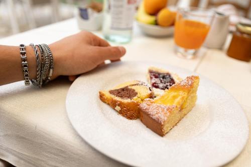 a plate with a piece of cake on a table at Agriturismo Le Bosche in San Marino