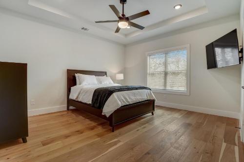 a bedroom with a bed and a ceiling fan at Munice at Trinity Grove in Dallas