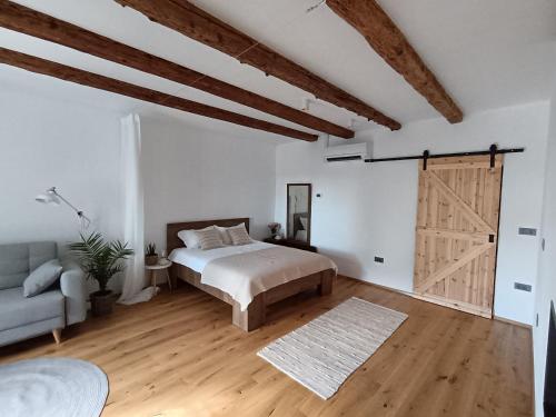 a bedroom with a bed and a sliding door at Country house in Marezige