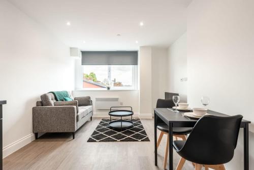 a living room with a table and a couch at Modern 1 Bedroom Apartment in Central Wakefield in Wakefield