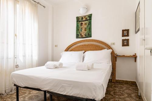 a bedroom with a white bed with towels on it at Monterosso al Mare! Seaview Flat in Monterosso al Mare