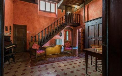 a hallway with a spiral staircase in a house at Villa Del Mosaico in Rignano sullʼArno
