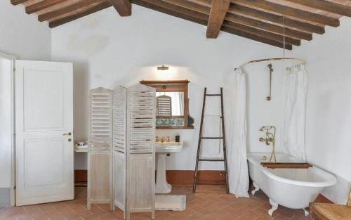 a bathroom with a white tub and a ladder at Villa Lotus Magliano in Magliano in Toscana