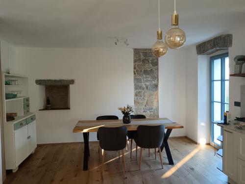 a kitchen and dining room with a table and chairs at Country house in Marezige
