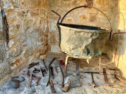 a metal bucket sitting on top of a brick wall at Le Mandrie Di San Paolo in Assisi
